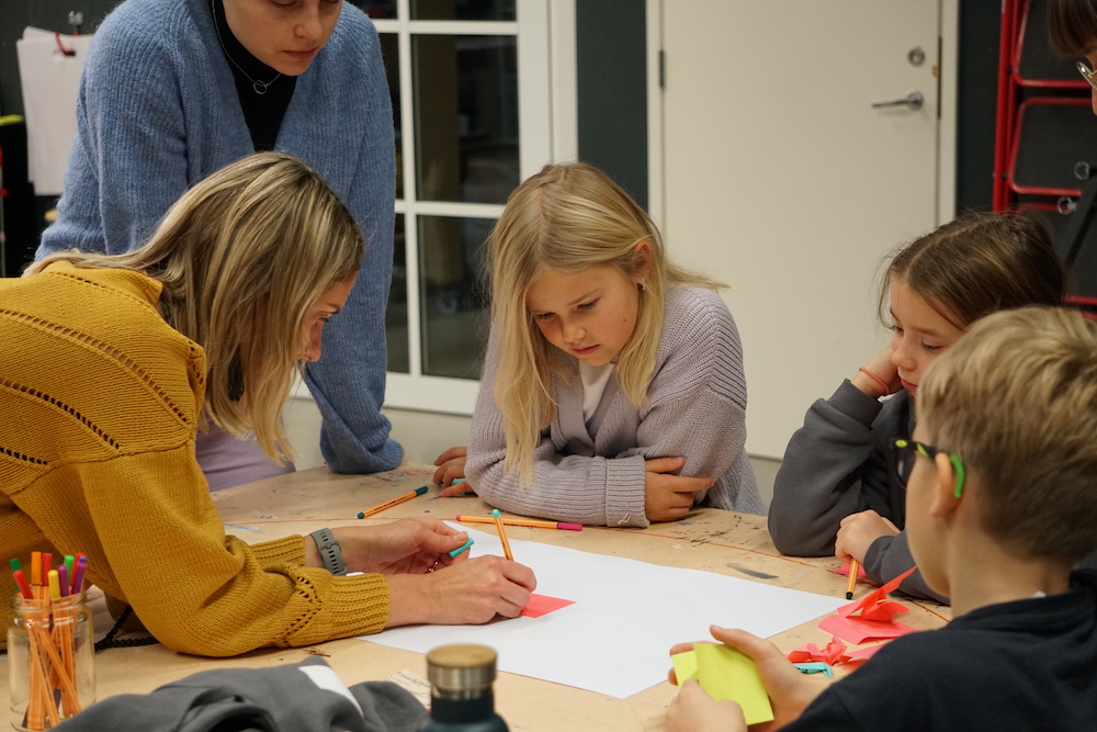 Kids brainstorming with adults